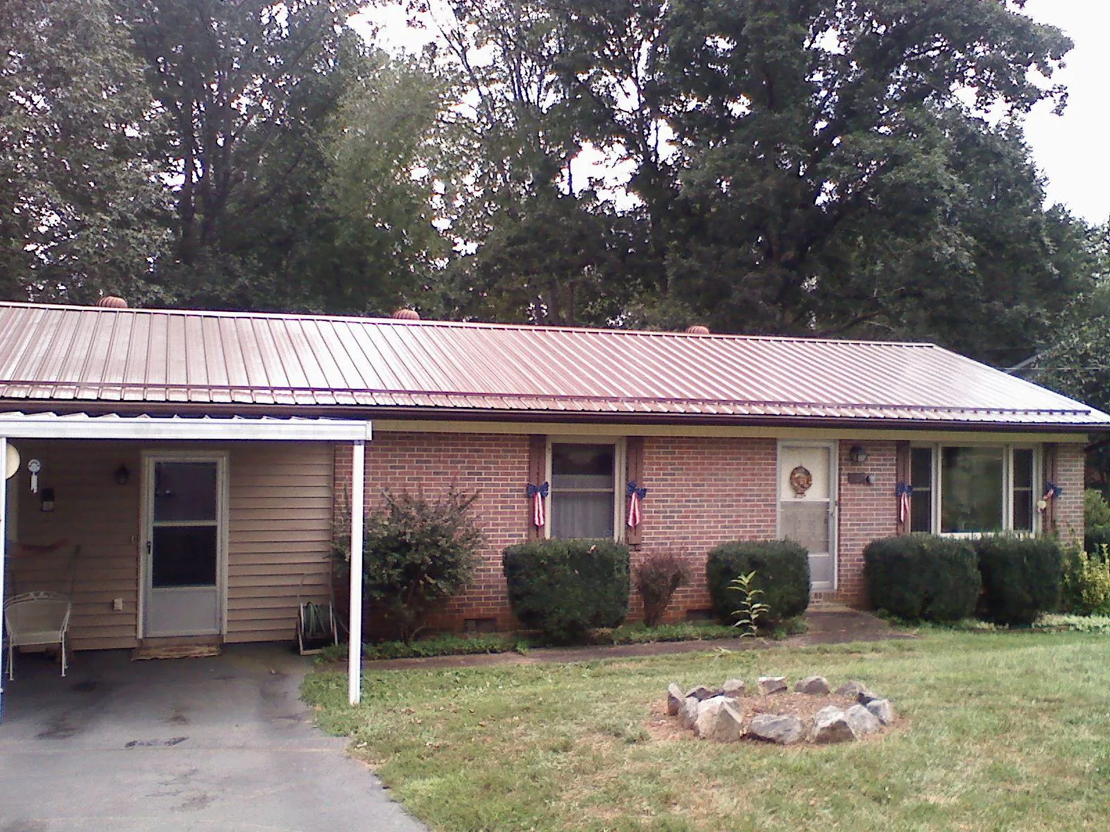 Bronze metal roof and carport on a brick ranch home — Roof Repair work by our crew in West Augusta